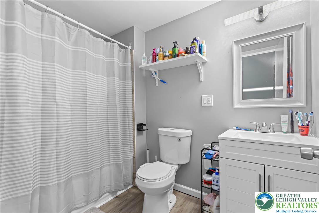 12 South Front Street Coplay, PA 18037 - Photo 26 of 41 This bathroom features a contemporary vanity and practical shower area, offering everyday comfort and style.