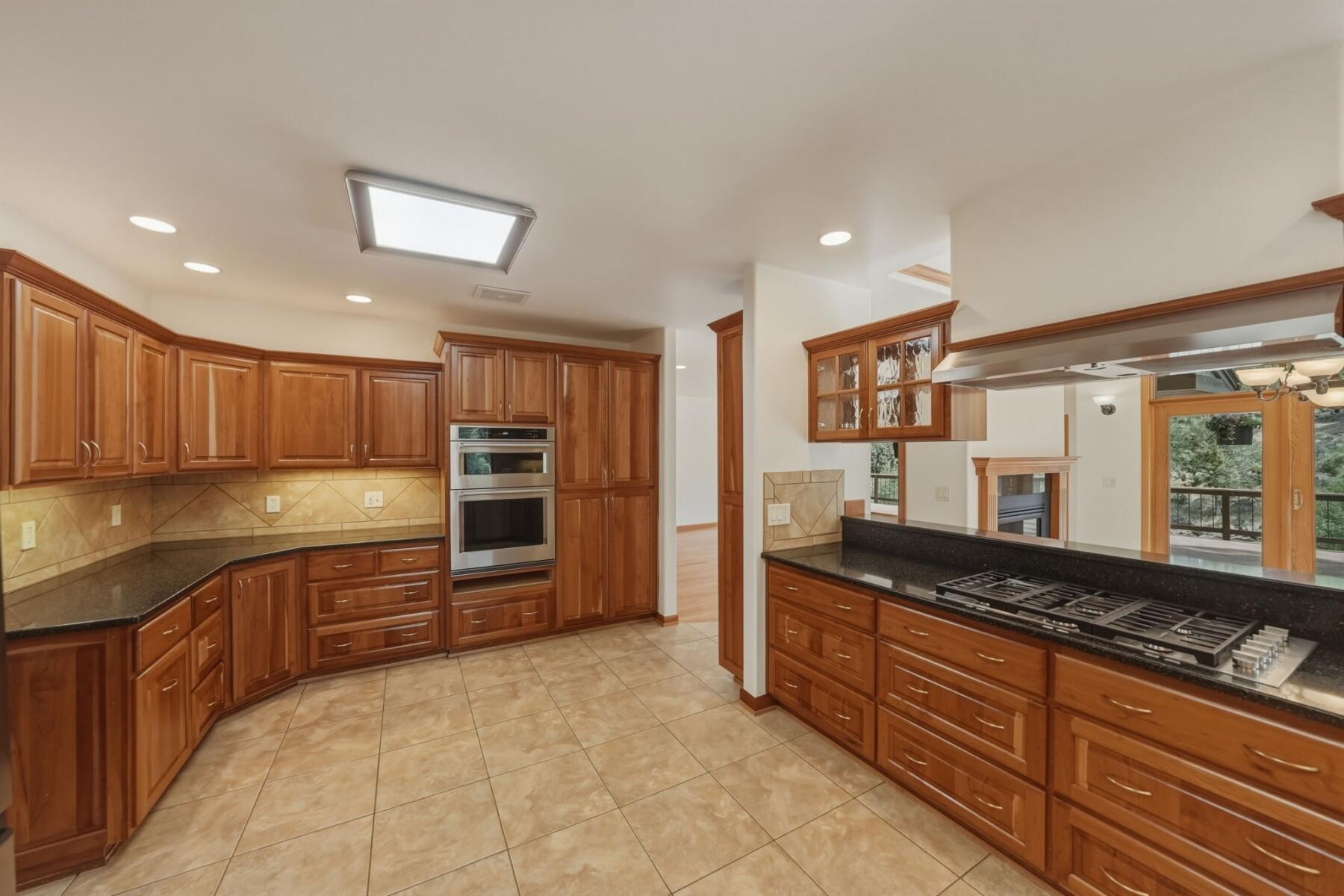 637 Northwest Silver Buckle Road Bend, OR 97703 - Photo 15 of 68 a large kitchen with granite countertop a stove and cabinets