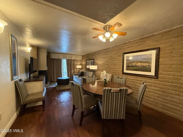 a view of a dining room with furniture wooden floor and chandelier