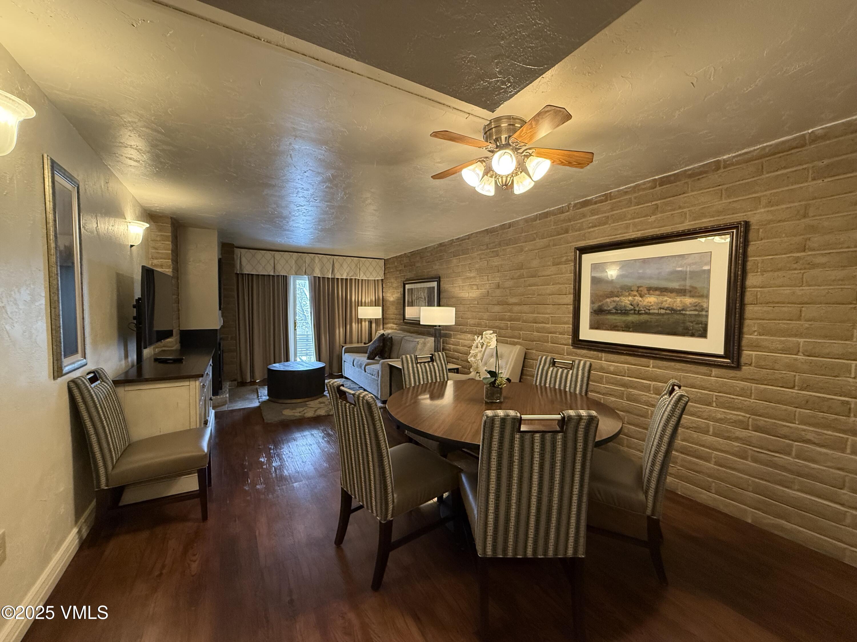 1020 Vail View Drive, Unit 130849 Vail, CO 81657 - Photo 3 of 20 a view of a dining room with furniture wooden floor and chandelier