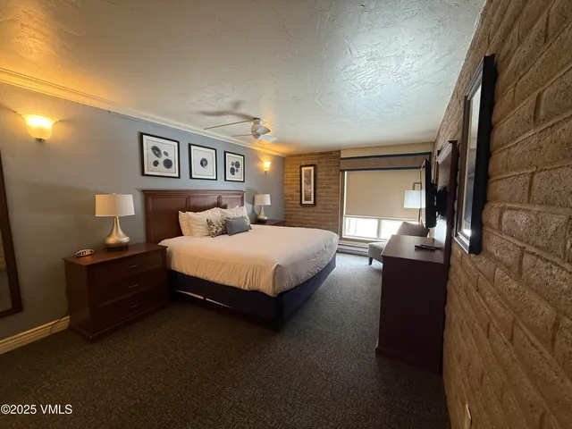 a bedroom with a bed and a night stand