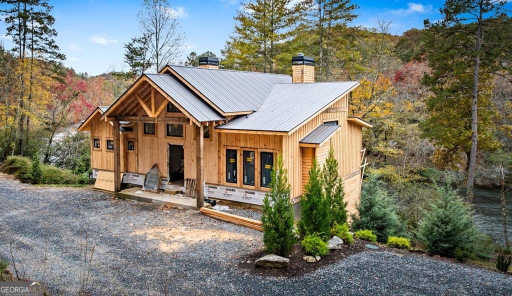 a view of a house with a yard and plants