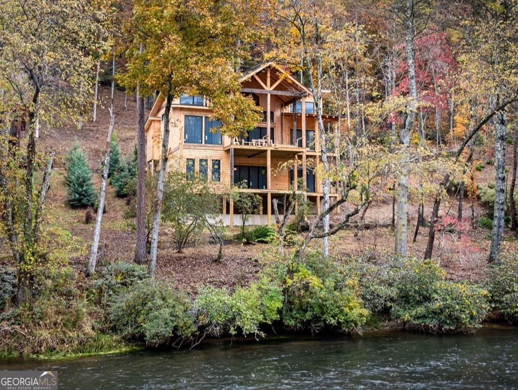 19 River Chase Way Mineral Bluff, GA 30559 - Photo 3 of 53 a front view of a house with a yard and a large tree