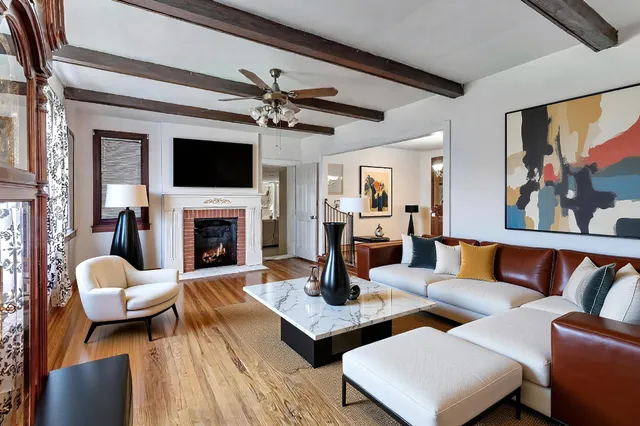a living room with furniture a fireplace and a flat screen tv