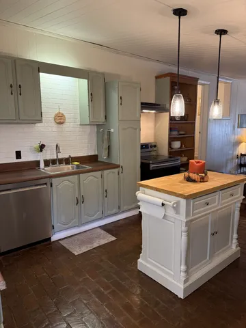 a view of a kitchen with a sink and chandelier