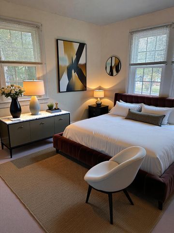 a bedroom with two beds and a large window