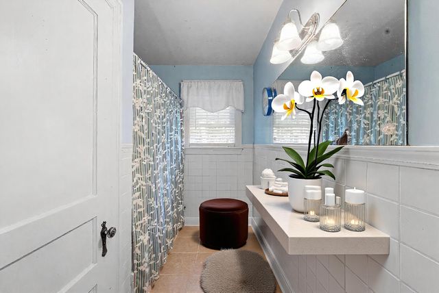 a bathroom with a sink a toilet and mirror