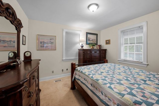 a bedroom with a bed and a desk