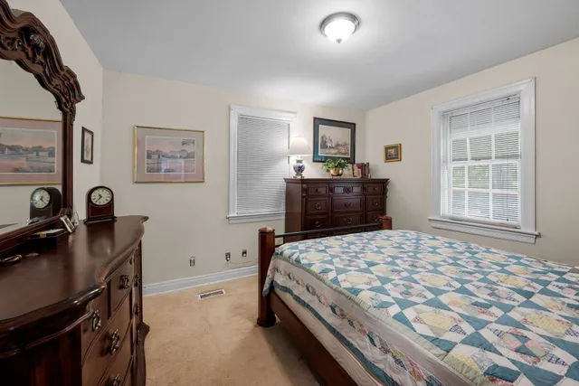 a bedroom with a bed and a desk