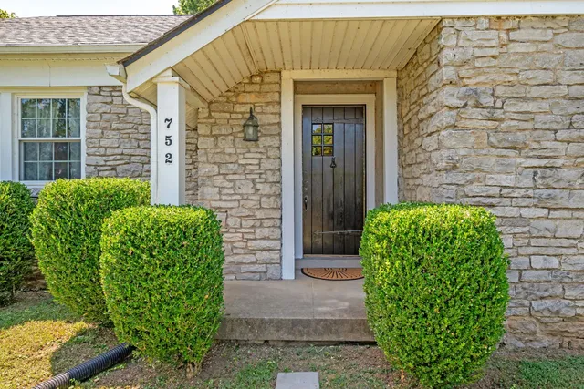 a front view of a house with a garden