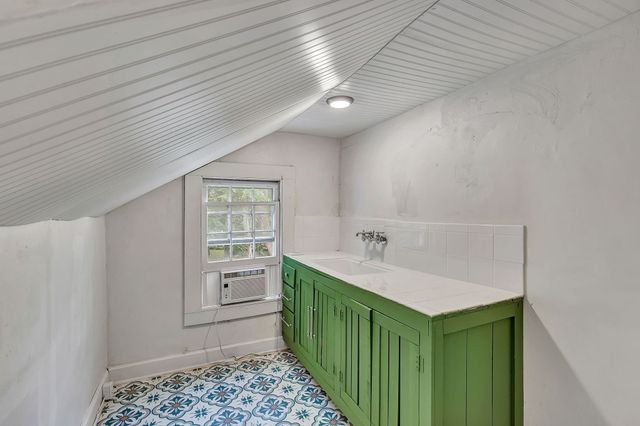 a bathroom with a double vanity sink and a window