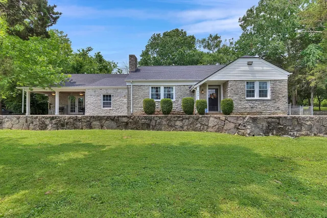 a front view of a house with a garden