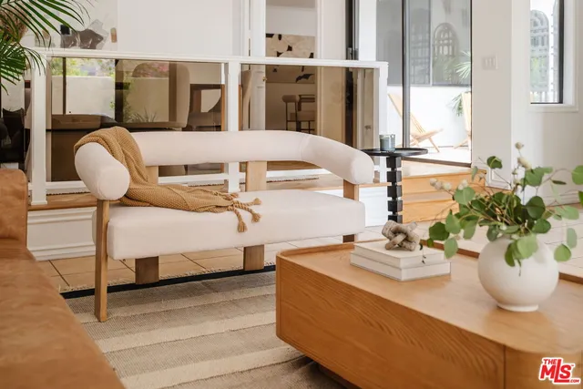 a view of living room with furniture and a potted plant