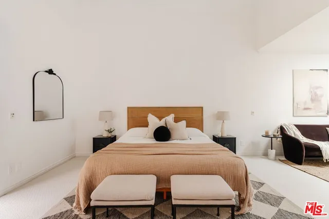 a bedroom with a bed and dresser