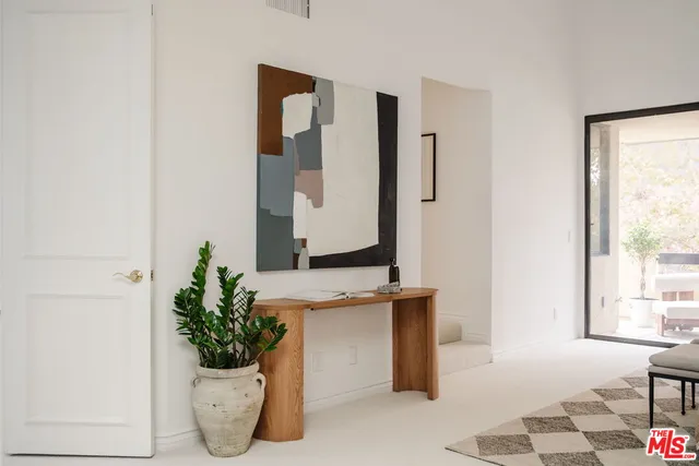 a bath room with a potted plant and a potted plant