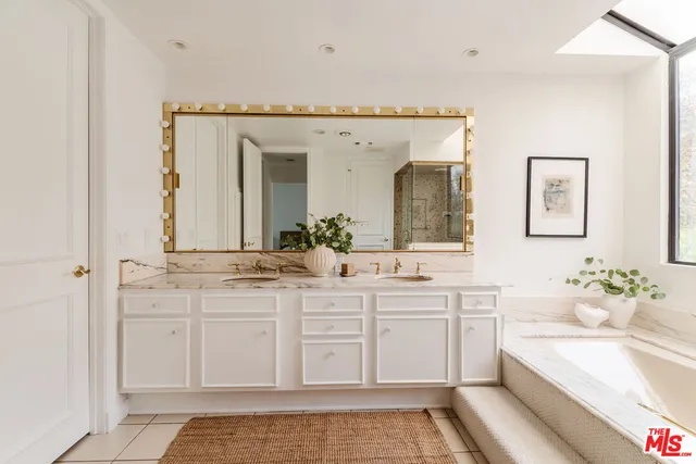 a spacious bathroom with a sink and a mirror