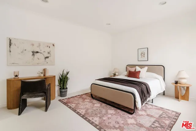 a bedroom with a bed and a desk