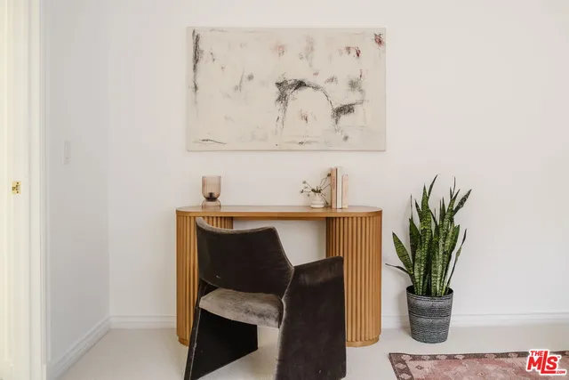 a room with a table and a potted plant
