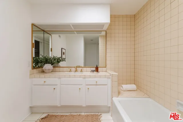 a view of a tennis ground with large trees