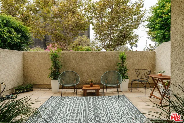 a backyard of a house with table and chairs