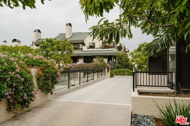 a view of a patio with a table and chairs under an umbrella