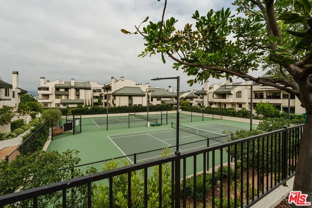 a view of a balcony and yard