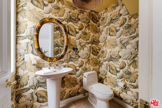 a bathroom with a sink mirror and toilet
