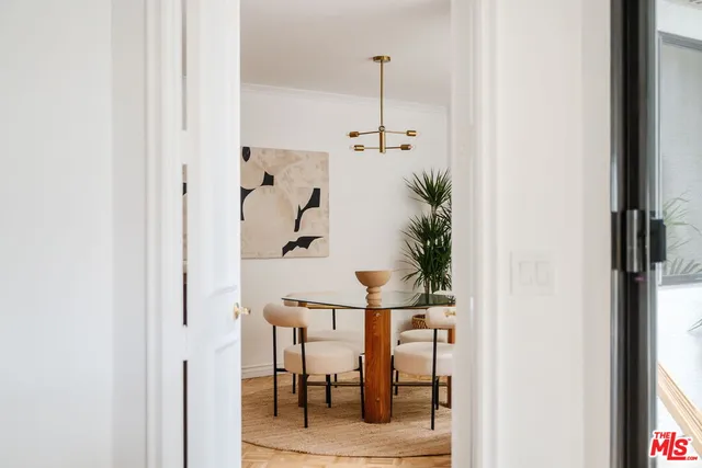 a view of a hallway with furniture and floor to ceiling window