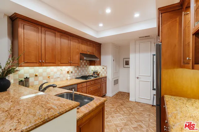 a kitchen with stainless steel appliances granite countertop a stove and a sink