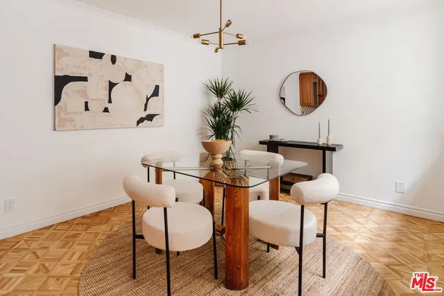 a dining room with wooden floor and breakfast area