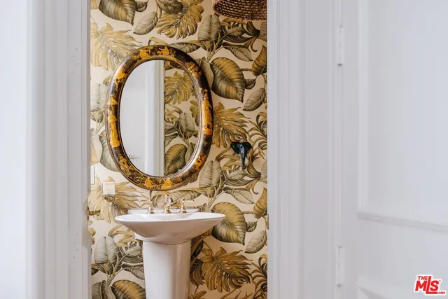 a view of a hallway with closet and mirror