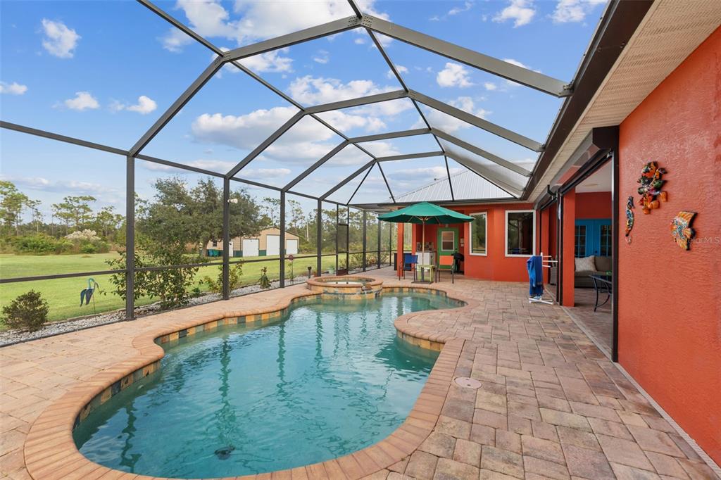 29336 Sam Way Punta Gorda, FL 33982 - Photo 2 of 44 a view of a swimming pool with a porch in front of it