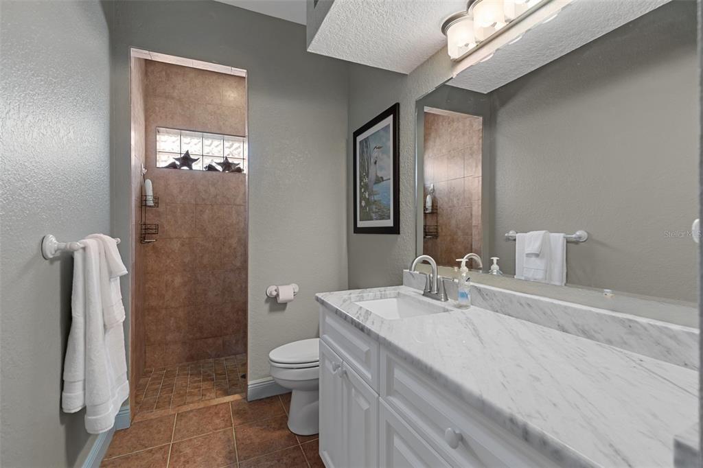 29336 Sam Way Punta Gorda, FL 33982 - Photo 22 of 44 a bathroom with a sink a toilet and shower