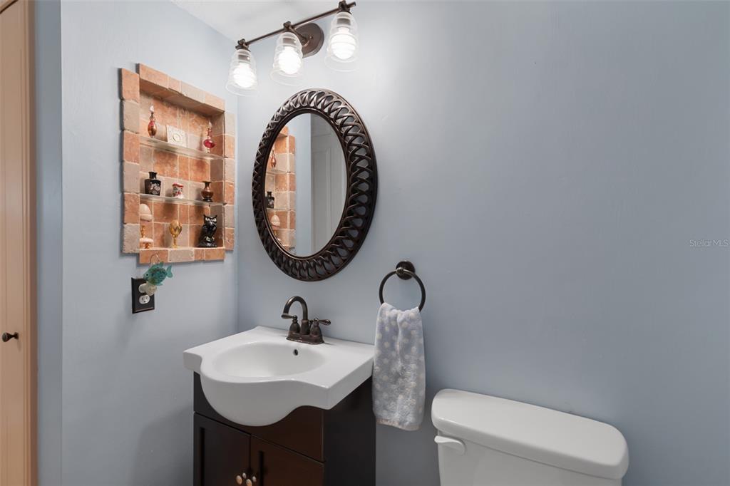 29336 Sam Way Punta Gorda, FL 33982 - Photo 25 of 44 a bathroom with a toilet a sink and a mirror