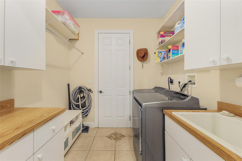 29336 Sam Way Punta Gorda, FL 33982 - Photo 26 of 44 a utility room with a sink and a stove top oven