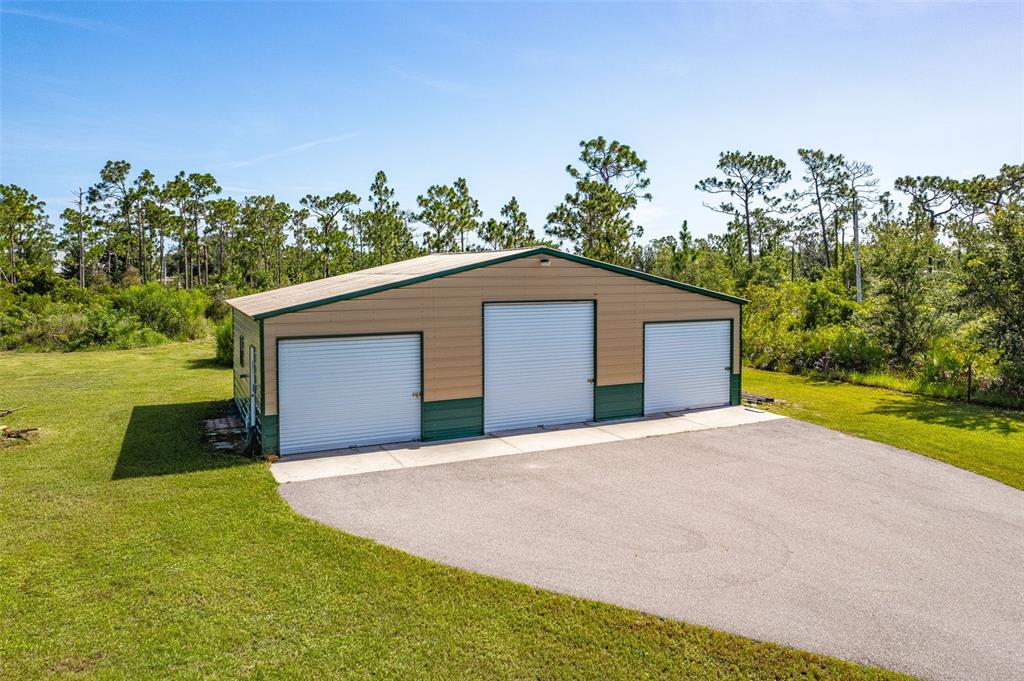 29336 Sam Way Punta Gorda, FL 33982 - Photo 33 of 44 a yellow house with trees in the background