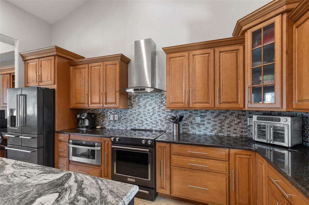 29336 Sam Way Punta Gorda, FL 33982 - Photo 8 of 44 a kitchen with stainless steel appliances granite countertop a stove sink and cabinets