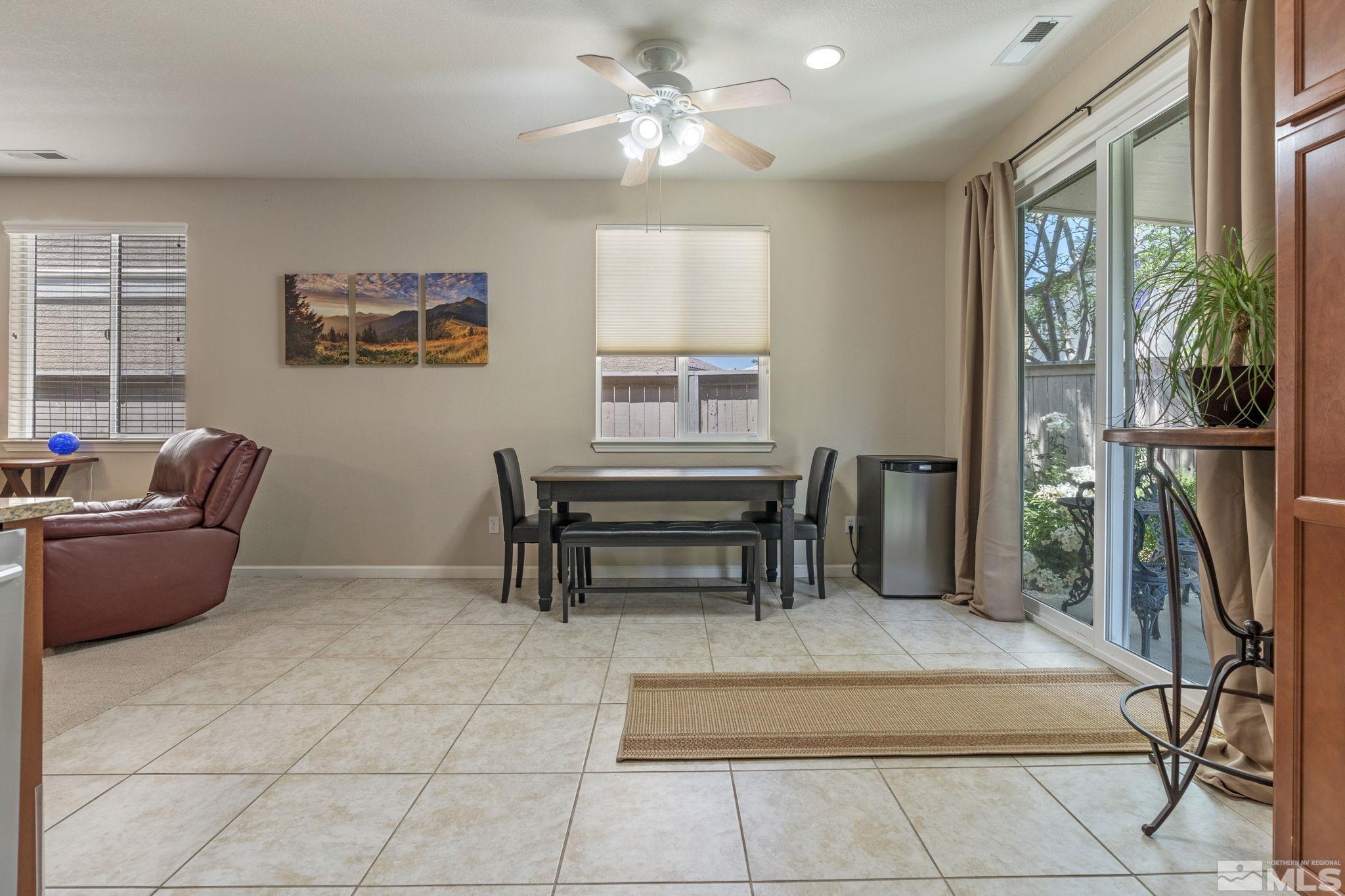 10848 Oakhaven Drive Reno, NV 89521 - Photo 11 of 32 a dining room with furniture and a floor to ceiling window