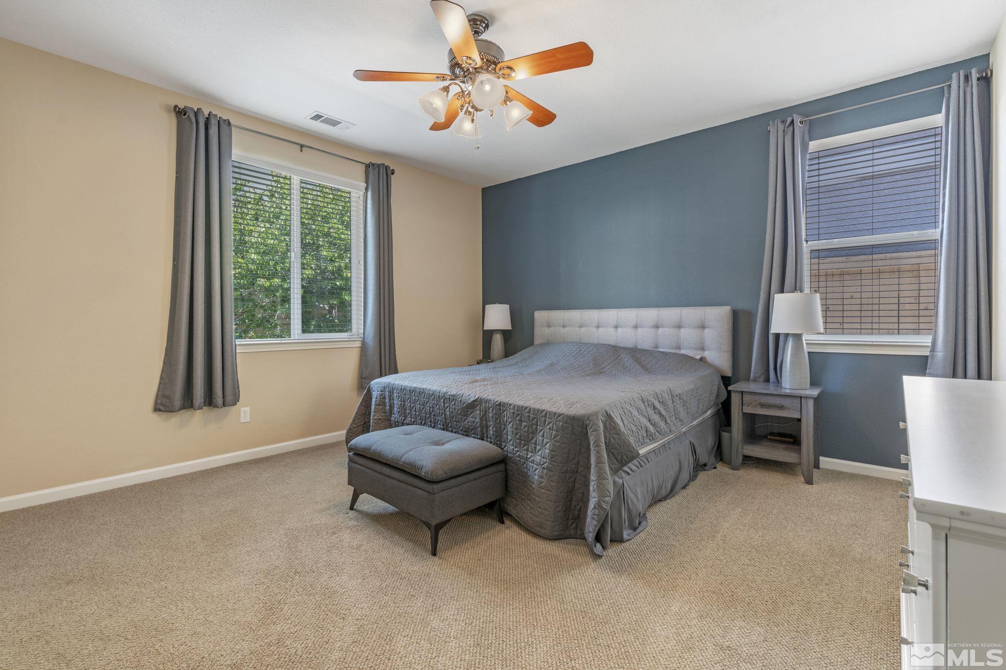 10848 Oakhaven Drive Reno, NV 89521 - Photo 19 of 32 a bedroom with a bed couch and window