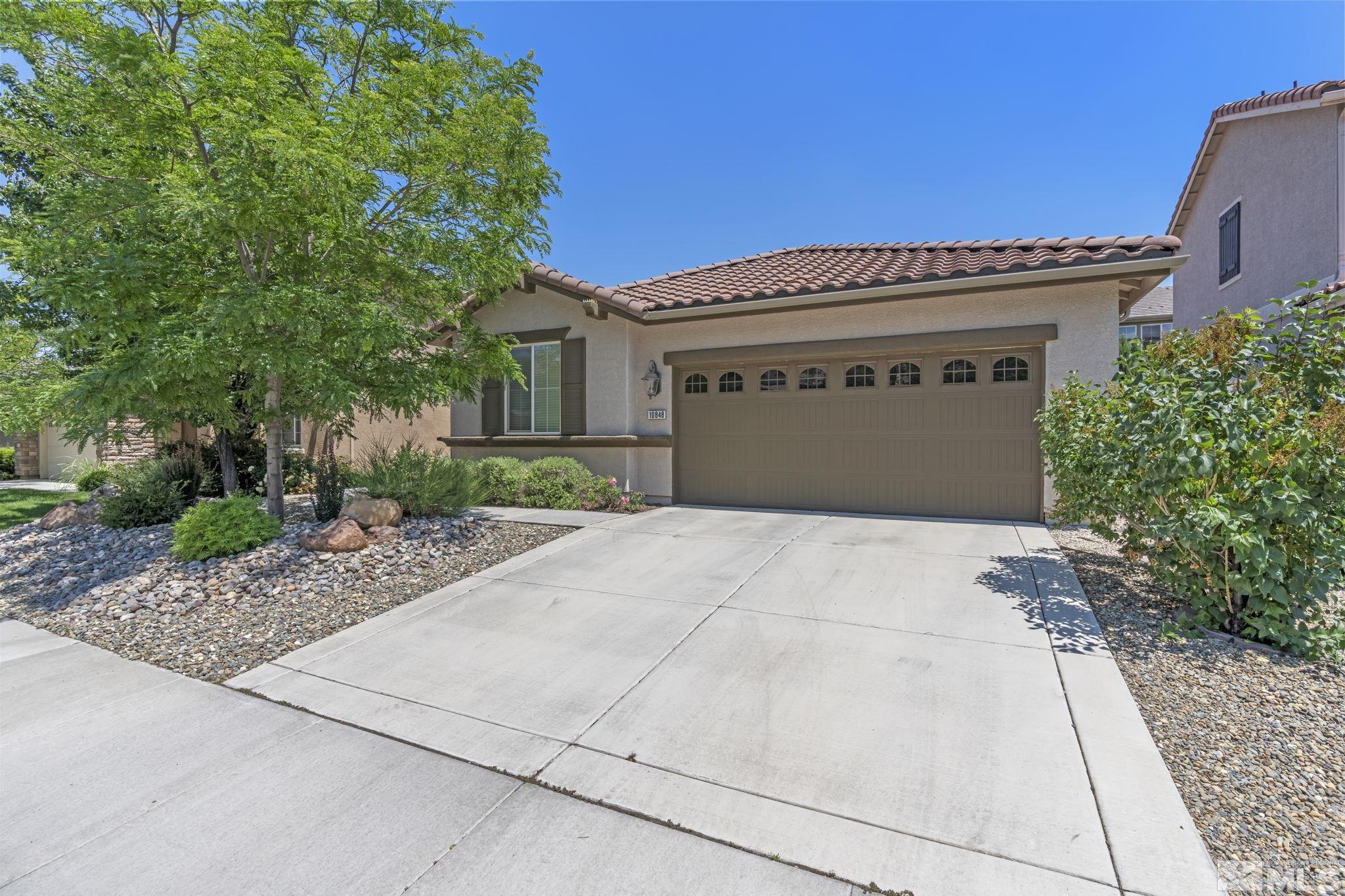 10848 Oakhaven Drive Reno, NV 89521 - Photo 2 of 32 a front view of a house with a garage