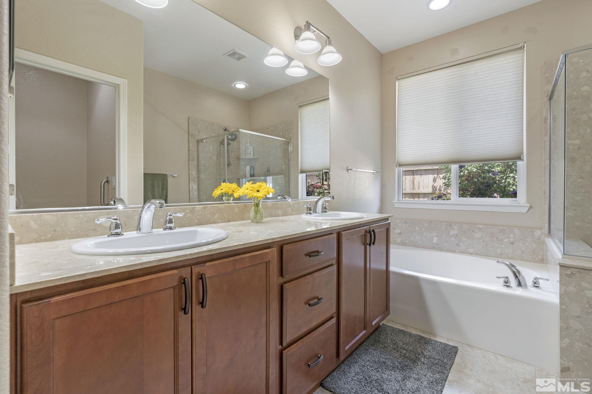 10848 Oakhaven Drive Reno, NV 89521 - Photo 21 of 32 a bathroom with a tub sink and mirror