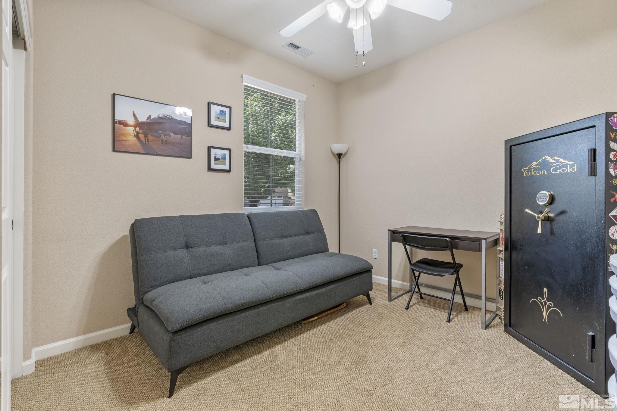 10848 Oakhaven Drive Reno, NV 89521 - Photo 24 of 32 a living room with furniture and a chandelier