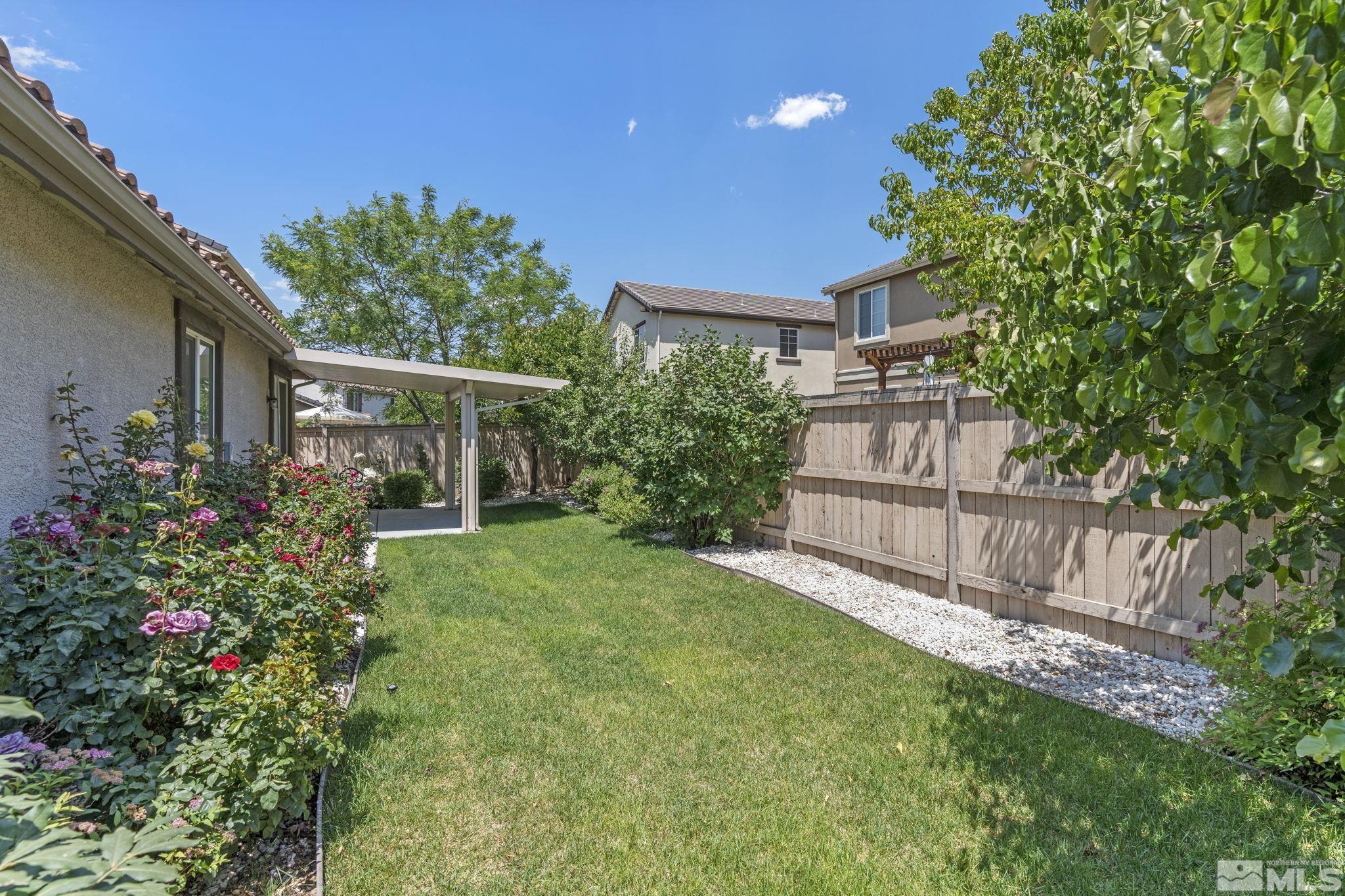 10848 Oakhaven Drive Reno, NV 89521 - Photo 31 of 32 a view of a house with big yard and potted plants