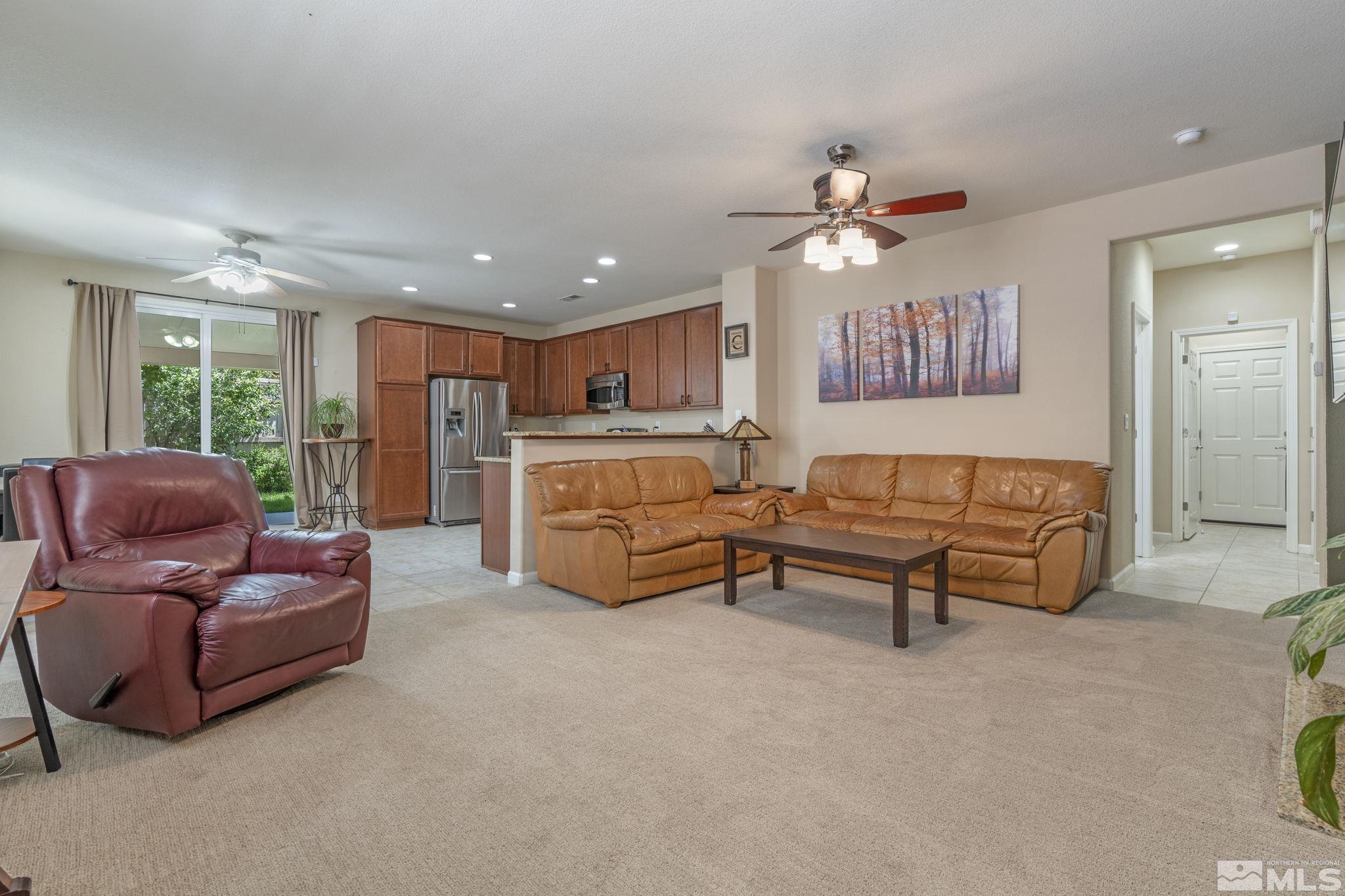 10848 Oakhaven Drive Reno, NV 89521 - Photo 5 of 32 a living room with furniture and a chandelier