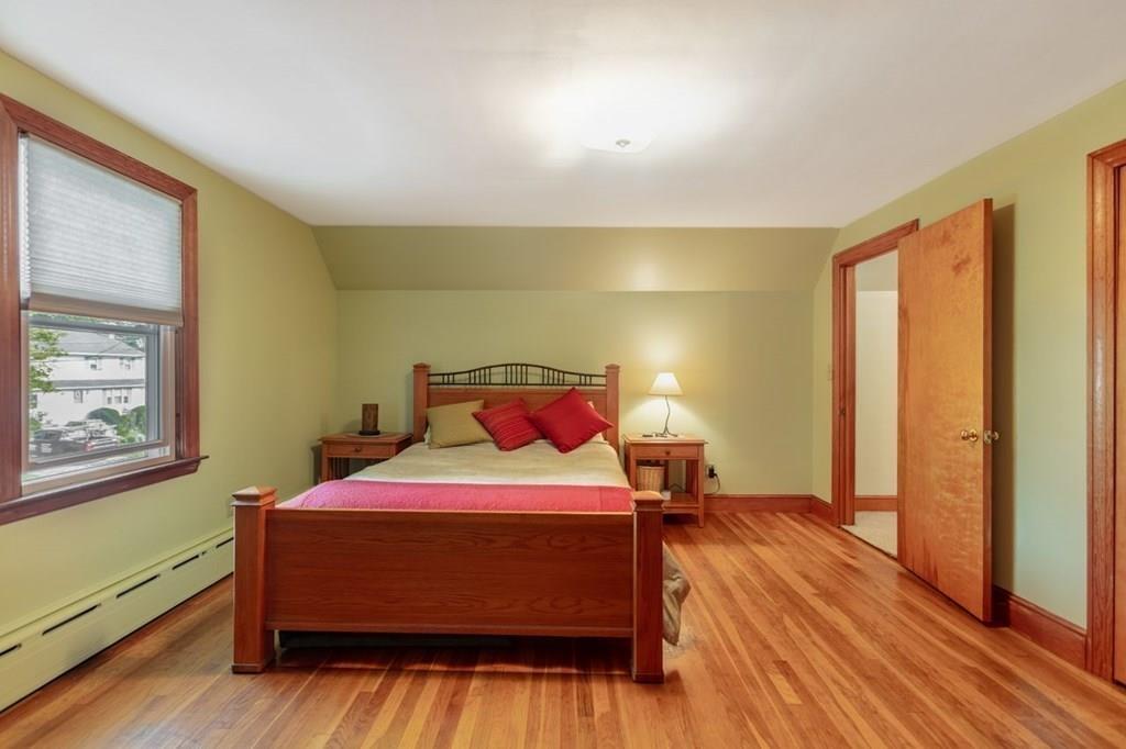 28 Pershing Avenue Framingham, MA 01702 - Photo 13 of 22 a bedroom with a bed and wooden floor