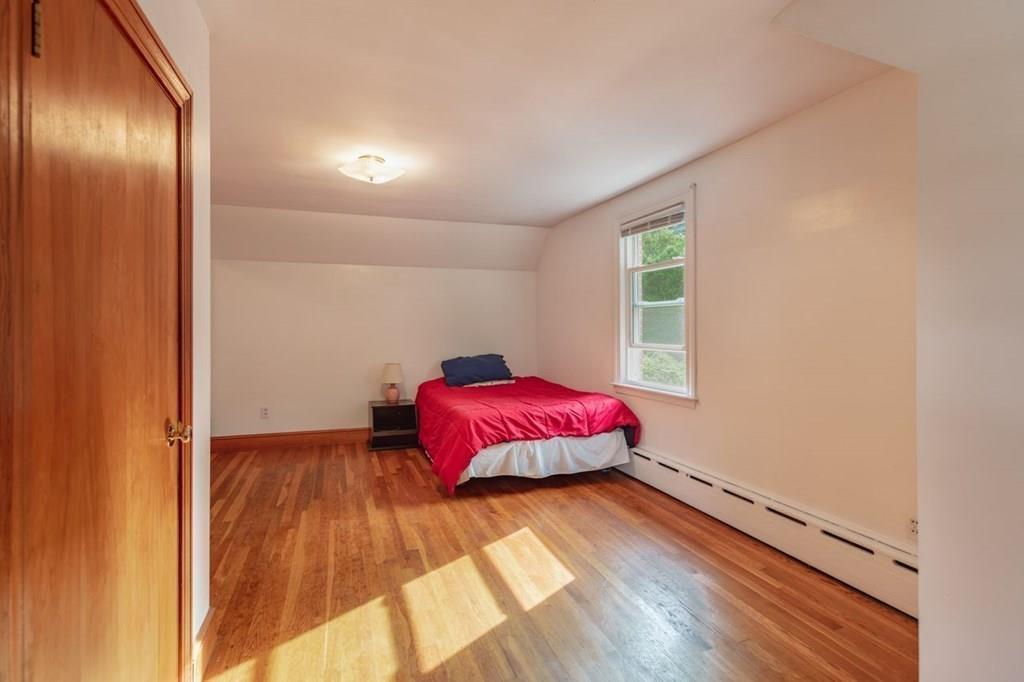 28 Pershing Avenue Framingham, MA 01702 - Photo 16 of 22 a spacious bedroom with a bed and wooden floor