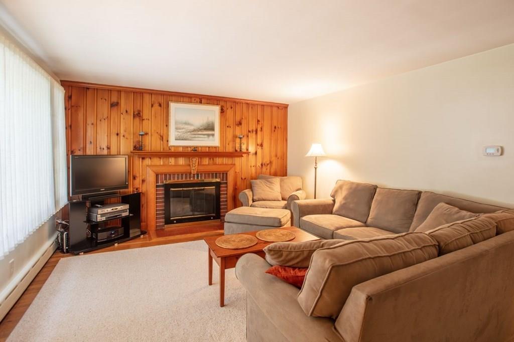 28 Pershing Avenue Framingham, MA 01702 - Photo 5 of 22 a living room with furniture a flat screen tv and a fireplace