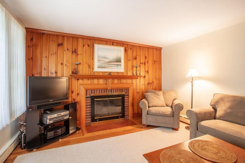28 Pershing Avenue Framingham, MA 01702 - Photo 6 of 22 a living room with furniture a fireplace and a flat screen tv