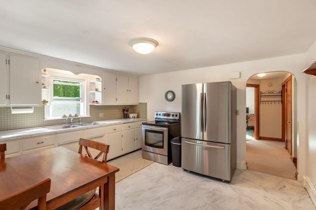 28 Pershing Avenue Framingham, MA 01702 - Photo 8 of 22 a kitchen with a refrigerator a stove and a sink