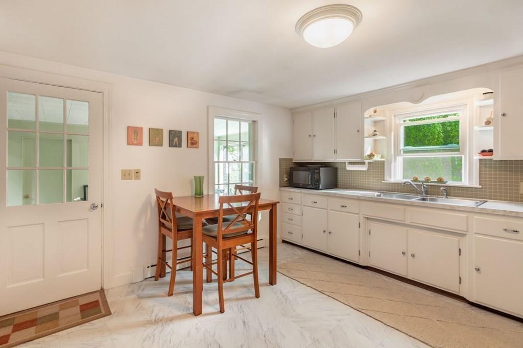 28 Pershing Avenue Framingham, MA 01702 - Photo 9 of 22 a kitchen with granite countertop sink table and chairs